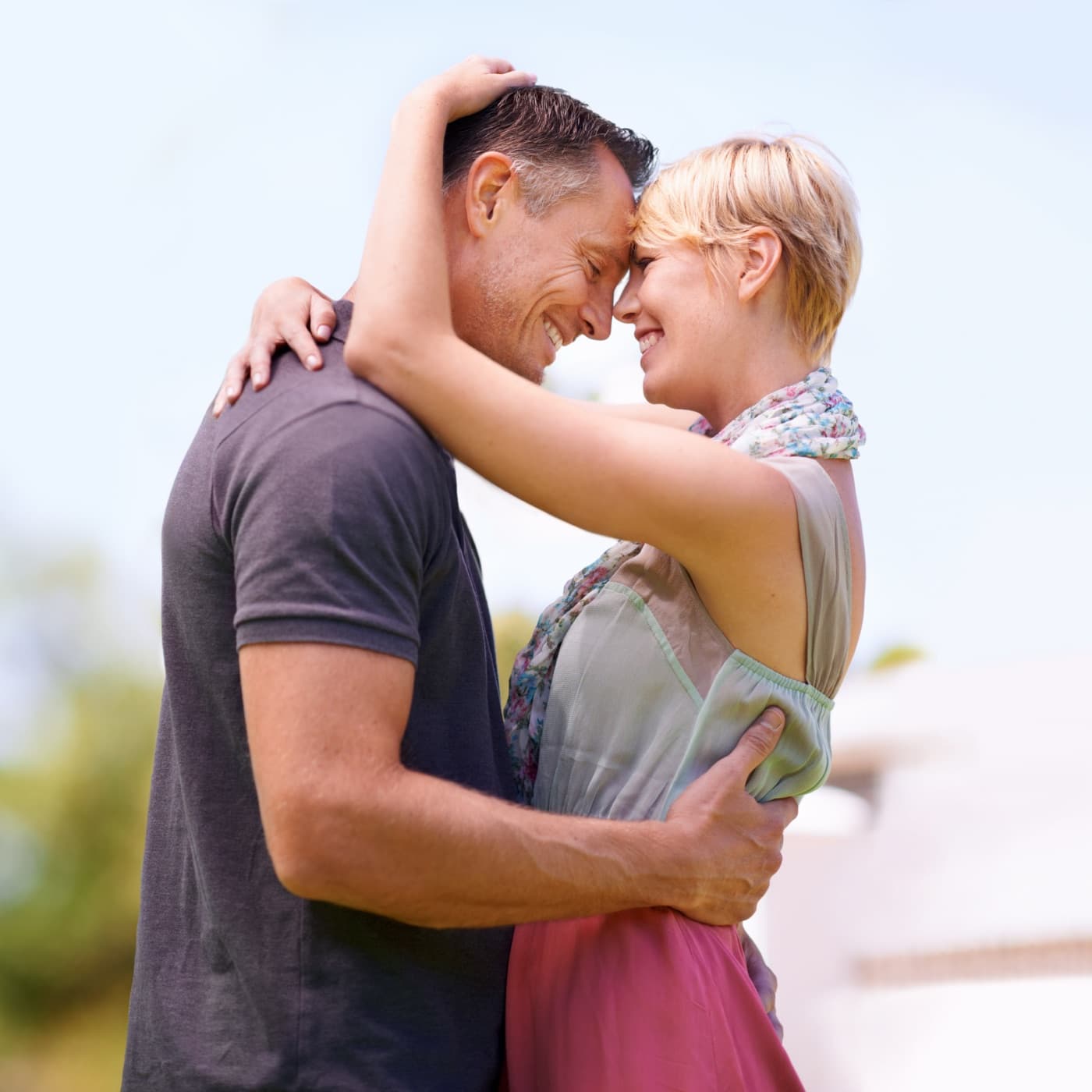 A couple embracing outdoors in warm daylight