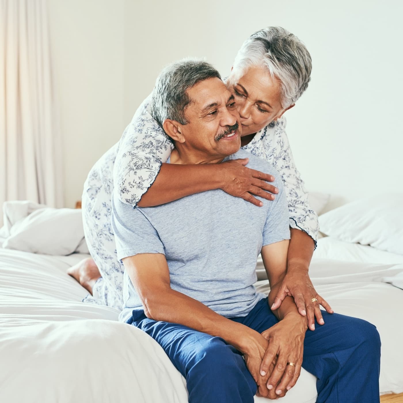 An older couple embracing on the bed