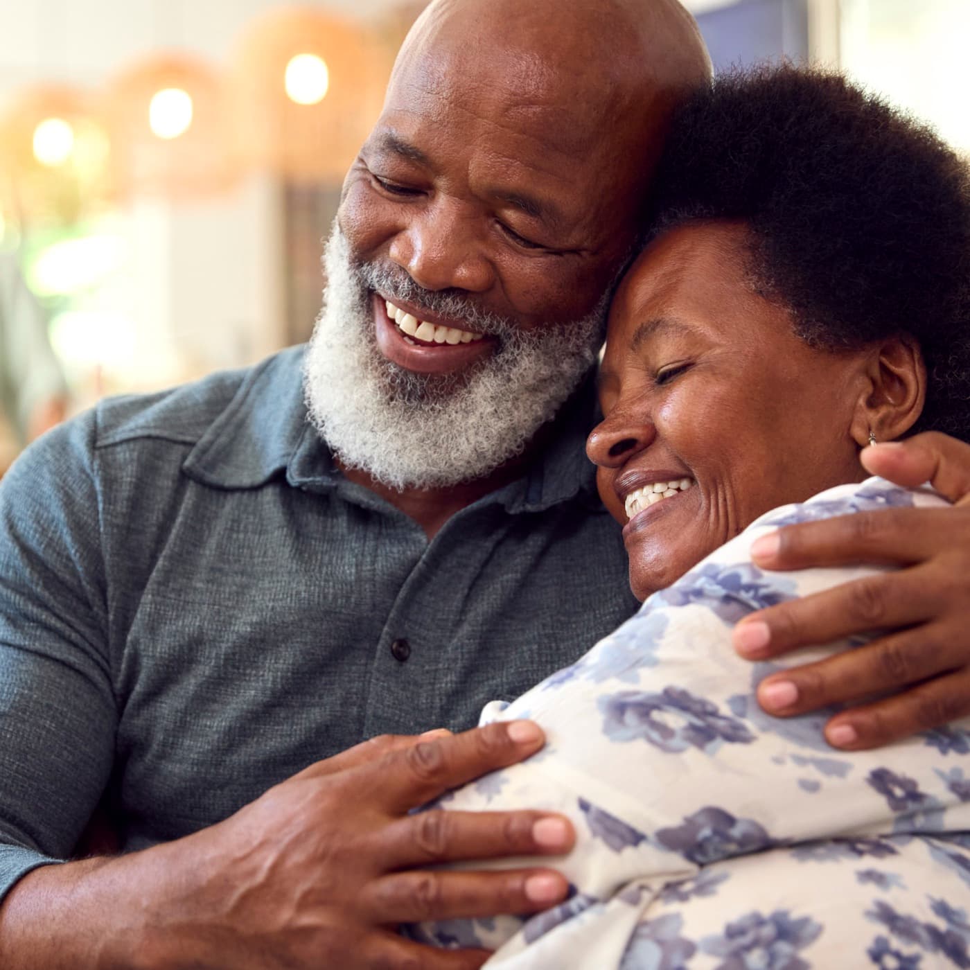 An older couple laughing together at home