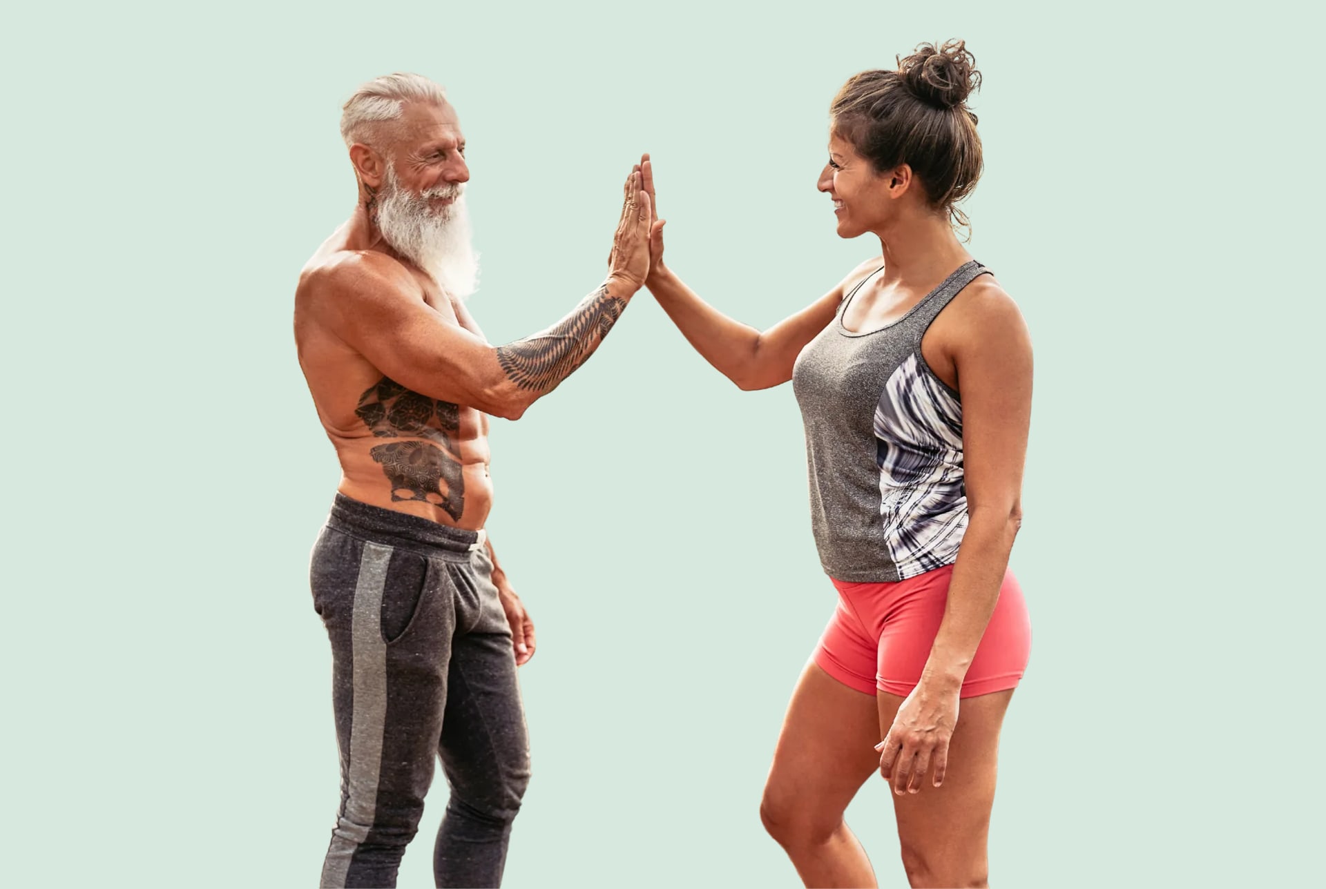 A white bearded man and a woman in gym clothes sharing a high five